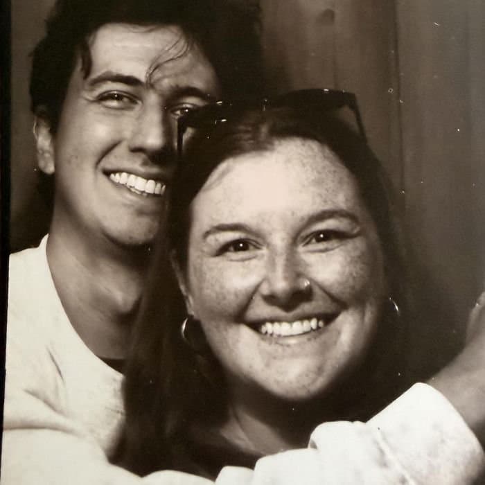 Devin and Megan cheek to cheek in a photo booth